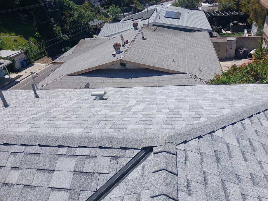 Finished light-gray architectural shingle roof planes, shown near the beginning of the second half of the San Pasqual roofing page.