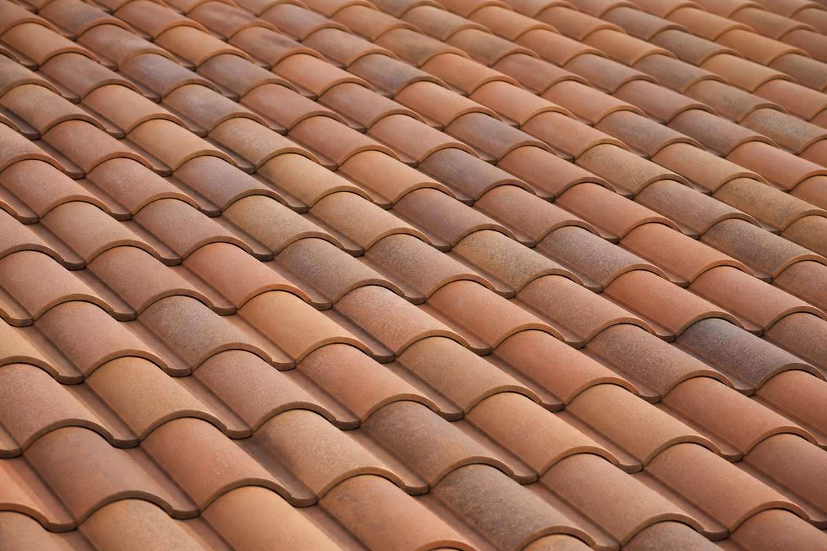Muted terracotta S tiles across a finished roof plane, shown near the beginning of the second half of the Pasadena roof repair page.
