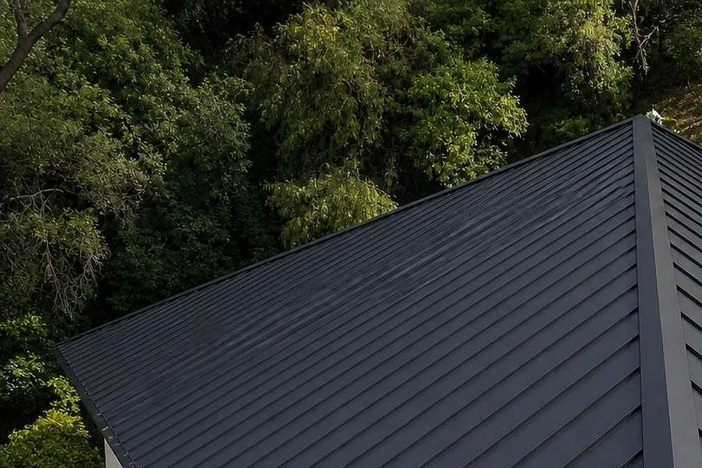 Finished standing-seam metal roof panels, shown near the beginning of the second half of the Pasadena commercial roofing page.