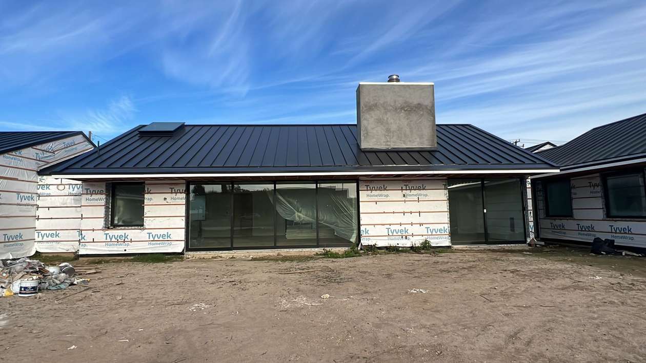 Finished standing-seam metal roof across a residential elevation, shown near the beginning of the second half of the South Pasadena roofing page.