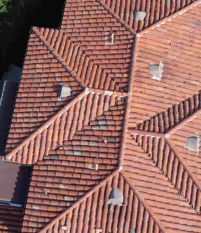 A weathered red barrel-tile roof with several hips, featured on the pasadena historic district roofing guide.